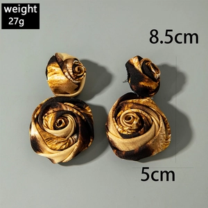 Macro shot of long leopard print fabric flower earrings showing 8.5cm size and texture