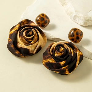 Macro shot of leopard print fabric rose earrings with matching resin beads and texture