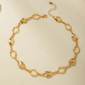 Detail of chunky gold punk chain necklace featuring organic textured metal links