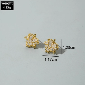 Detailed view of maple leaf stud earrings with gold plating and cubic zirconia stones