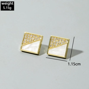 Detailed view of square stud earrings with pave crystals and white shell texture