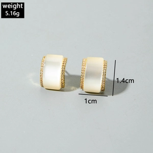 Detail showing gold rectangular earrings with cat-eye stone and small zircon border