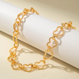 Punk style golden heart-shaped link chain necklace for women on white display stand