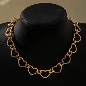 Detailed view of the gold heart-shaped chunky chain link necklace on a black mannequin