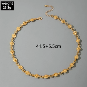 Macro shot of gold punk chain necklace featuring cross star textures and lobster clasp