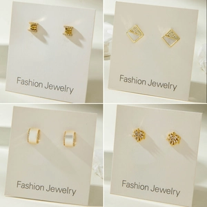 Elegant gold earrings set featuring crystal studs, maple leaf and square shell designs