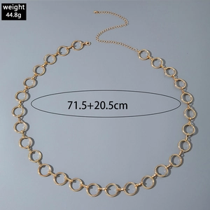 Detailed view of golden metal ring waist chain with lobster clasp and adjustable extension