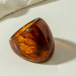 Macro detail of amber resin ring showing unique smoke textures and polished finish