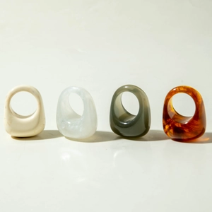 Minimalist acrylic resin rings set with marble, mother of pearl, amber, and green finishes