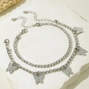 Detail of silver butterfly layered anklet with sparkling rhinestones and lobster clasp