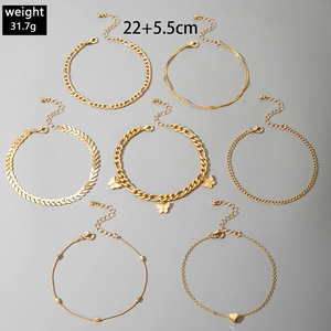7-piece gold anklet set with butterfly and heart charms showing 22+5.5cm measurements