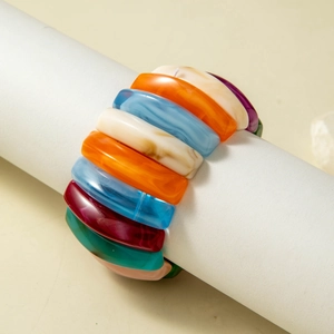 Macro view of colorful acrylic resin blocks on an elastic chunky stretch bracelet