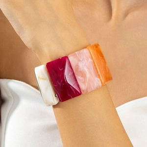 Macro detail of colorful acrylic stretch bracelet featuring marble texture resin blocks