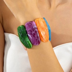 Detail shot of colorful acrylic resin bracelet with marbled green and orange patterns