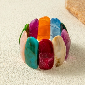 Detailed shot of colorful acrylic stretch bracelet with marble textures and boho style