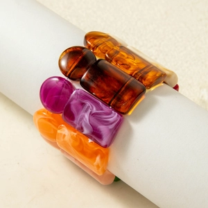 Detailed macro view of retro acrylic bangles in amber and purple marble textures