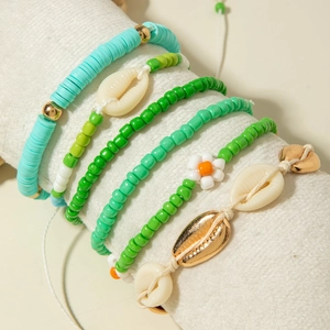Detailed view of bohemian 5-piece bracelet set with seashells and mint green beads