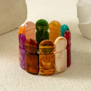 Detailed view of colorful humanoid acrylic elastic bracelet with marble texture