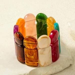 Detailed view of colorful acrylic link bracelet featuring abstract human-shaped beads