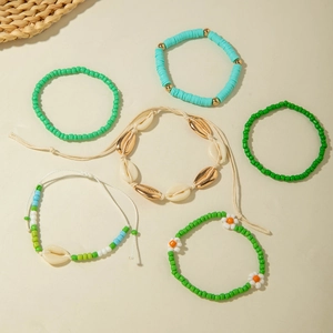 Detail of 6-piece bohemian beach bracelet set with starfish shells and green beads