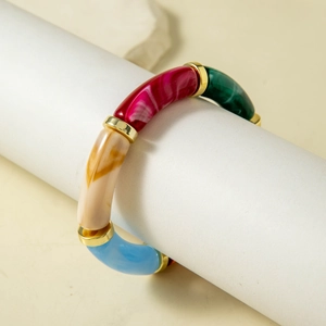 Detailed close-up of colorful acrylic marble beads with gold metal spacers on a bracelet