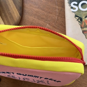 Close-up of cute bear stationery pouch with yellow lining and interior pocket compartment