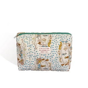 Quilted cotton cosmetic bag with blue star and circus animal patterns on white fabric