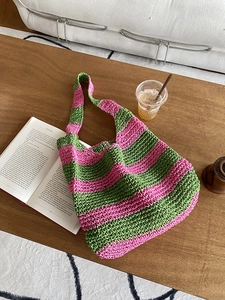 Detail of pink and green striped handmade woven tote bag with openwork knit texture