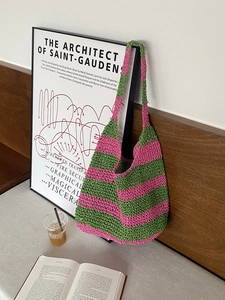 Macro detail of hand-knitted tote bag with pink and green striped crochet texture