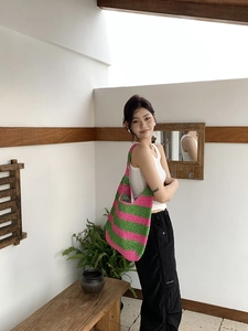 Detail of pink and green striped crochet beach bag with handmade woven texture and large capacity