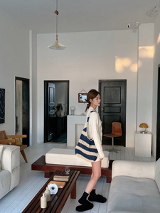 Detail of blue and beige striped woven shoulder bag showing fine knitted texture and craft