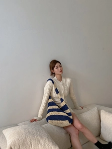Detail of navy and beige striped knit shoulder bag with woven texture on a model