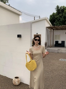 Street style view of large capacity yellow handwoven hollow shoulder bag for summer beach