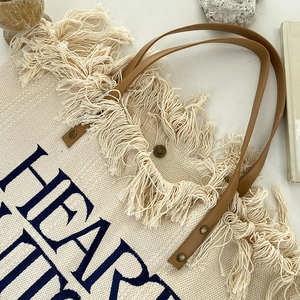 Bohemian beige canvas tote bag with heart embroidery, fringe detail and leather handles