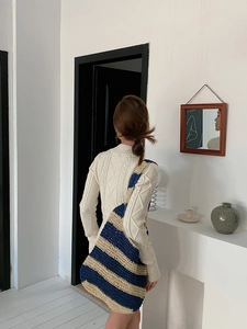 Detail of navy and beige striped woven shoulder bag with textured knit fabric