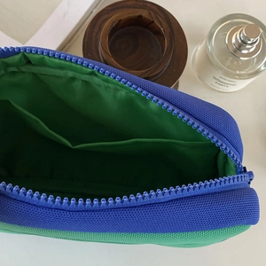 Large capacity storage bag with blue and green canvas panels and interior compartment