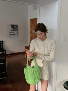 Detailed close-up of a handmade green crochet woven bag with hollow mesh pattern