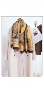 Detail of sunflower oil painting jacquard scarf with fine fringe on beige coat