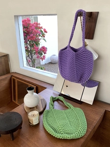 Close-up of handmade crochet texture in purple and green cotton woven shoulder bags