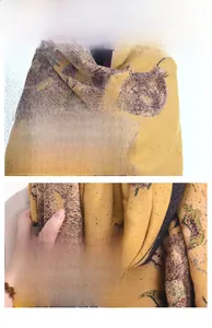 Close-up of yellow knit scarf showing sunflower oil painting print and fine texture