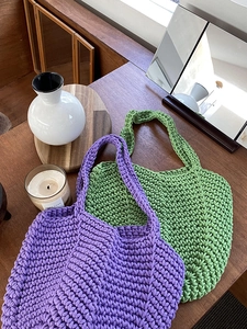 Detail showing the thick woven texture and purple hand-knitted cotton rope of the bag