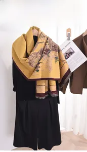 Detail of warm yellow scarf with sunflower oil painting print and fringed edges
