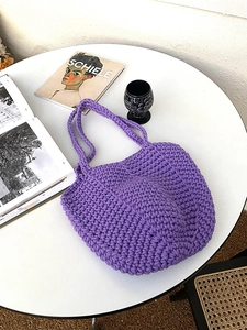 Detail of purple hand-woven crochet tote bag showing thick cotton knit texture and style