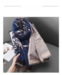Detailed view of navy blue and beige winter scarf with bamboo leaf print and tassel edges