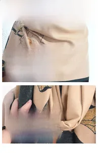 Macro detail of apricot cashmere-feel scarf with lotus flower print and green edges
