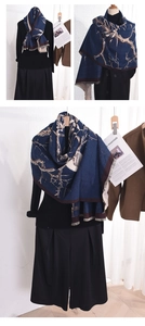 Detail of dark blue scarf with tree branch prints and elegant fringe tassel edges