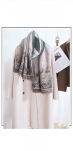 Detail of artistic jacquard cashmere scarf with fringes over a stylish wool coat