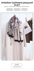 Detail of winter scarf showing red plum blossom jacquard and elegant black tassels