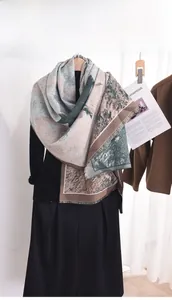 Detailed close-up of cashmere-like scarf showing artistic print and frayed fringe edges