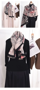 Detail of winter scarf with red plum blossom print and elegant tassel edges